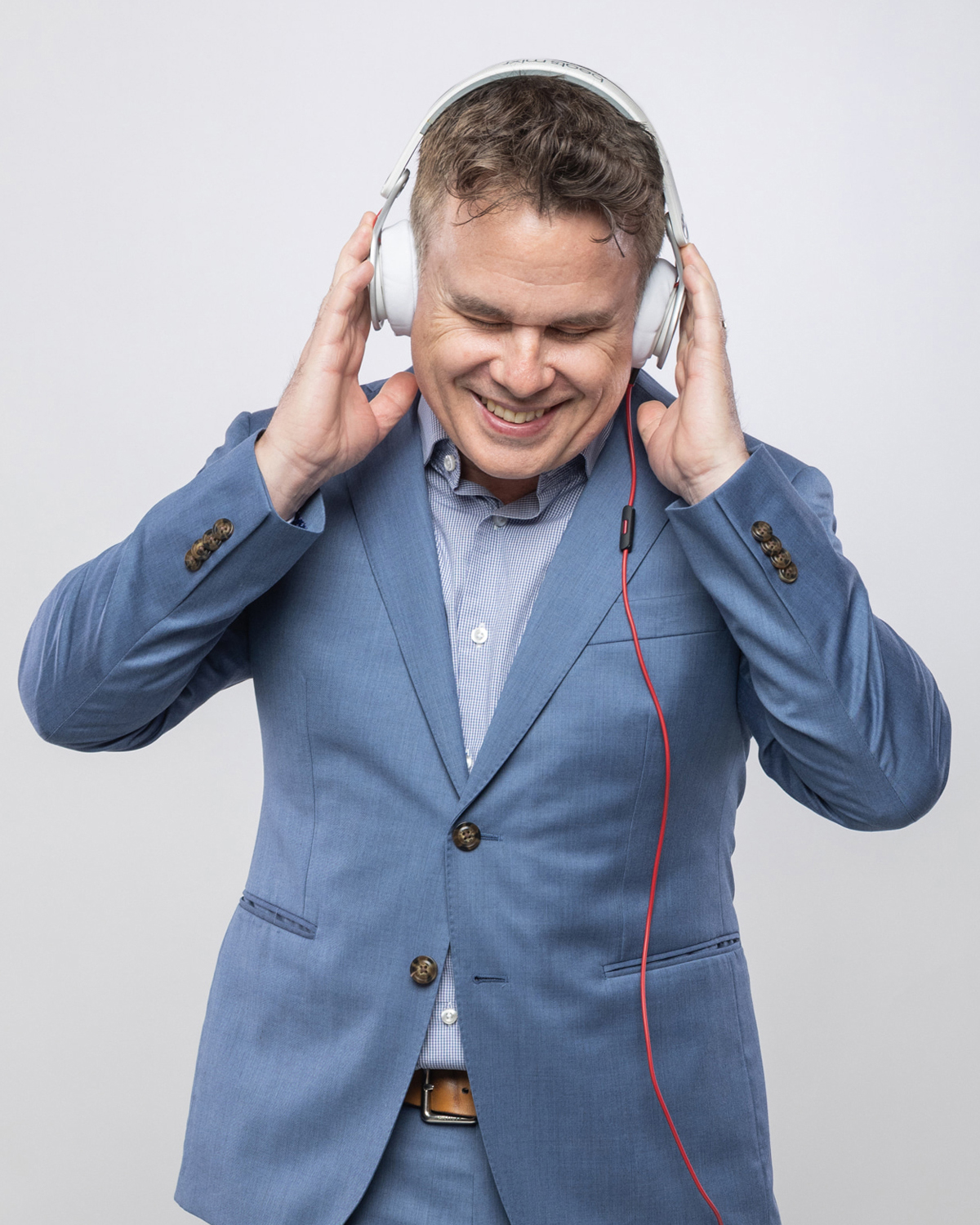 DJ Graeme Ritchie smiling while wearing headphones