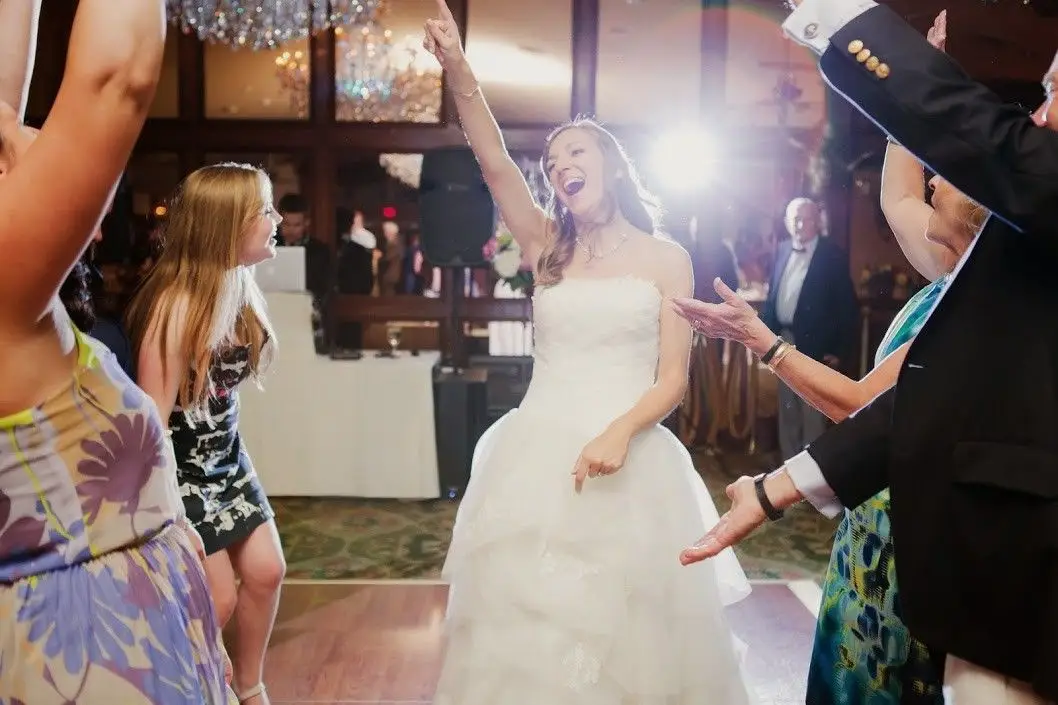 Bride celebrating on the dance floor at Saint Clements Castle
